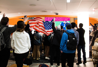SU students celebrate the U.S. win against Iran by chanting “U.S.A” and waving an American flag. Many students wore items representing the countries they were rooting for as they watched the games. 